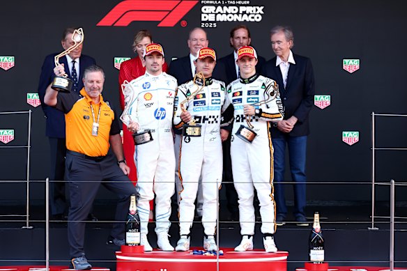 McLaren CEO Zak Brown on the podium with Charles Leclerc (second), Lando Norris (race winner) and Oscar Piastri (third).