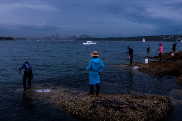Fishing at Laings Point in Watsons Bay as a summer storm tracks over Sydney from the west. 