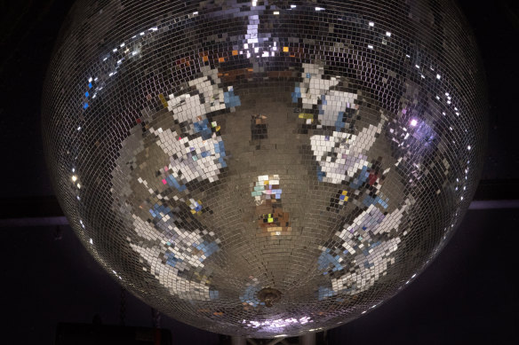 Reflected on a mirror ball, health workers have a coronavirus test ahead of a music concert in Barcelona, Spain in March.