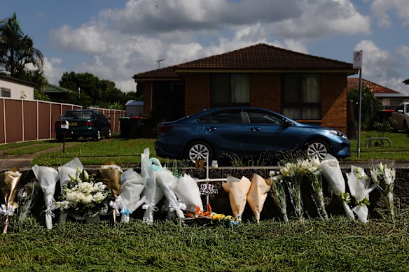 Flowers at the site where two teenage boys were killed when the motorbike they were riding collided with a commuter bus.