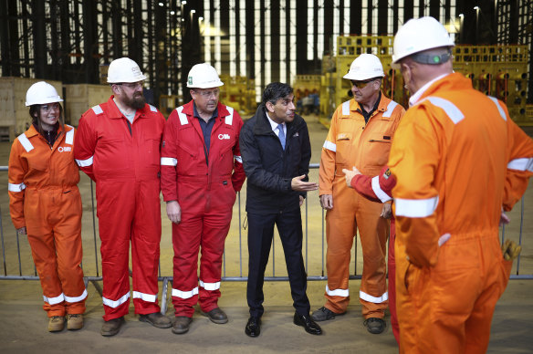 Conservative Party leader Rishi Sunak speaks with staff at the Global Energy Group facility at a campaign event at the Port of Nigg, Scotland.
