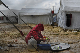 A child washing dishes inside the foreign fighters section of al-Hawl camp in April.