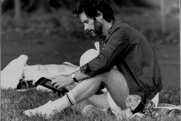 A cricket game between authors and publishers at Centennial Park in 1987. James Cowan reads while awaiting his turn to bat.