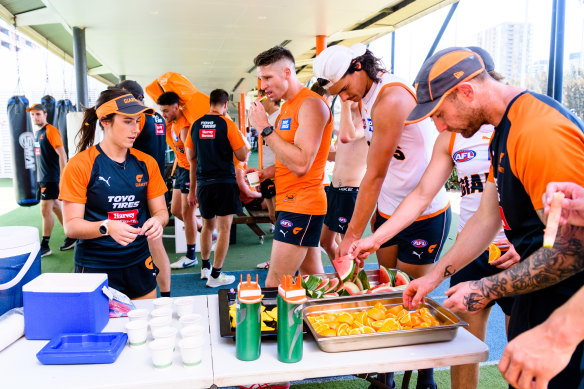 Dietitian Mel Juergens with Giants players eating post-training ahead of their finals match against Collingwood.