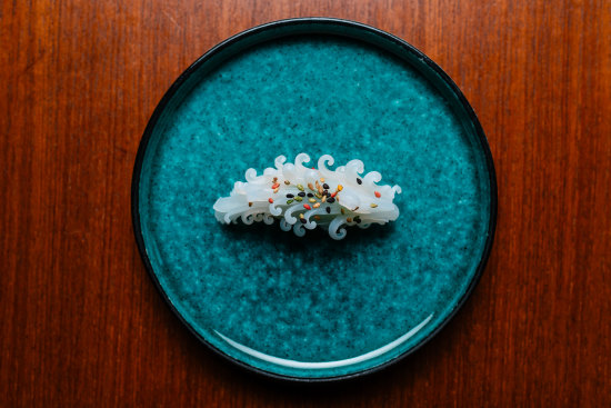 Squid sushi is cut to resemble a pine cone.