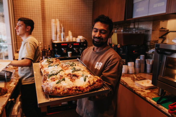 Margherita pizza slices ready to go at Self Raised.