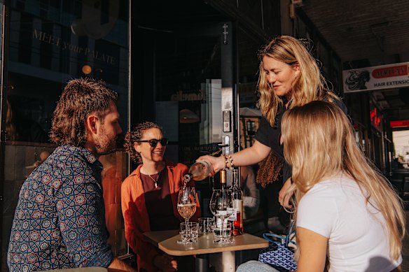 Amelia Birch pours wine for guests at her Enmore Road wine bar.