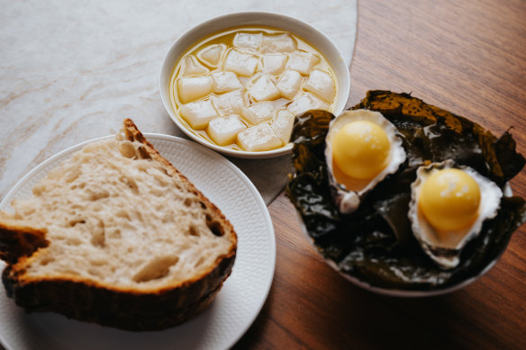 Abrolhos scallops in bull kelp oil, served with bread and cultured butter orbs.