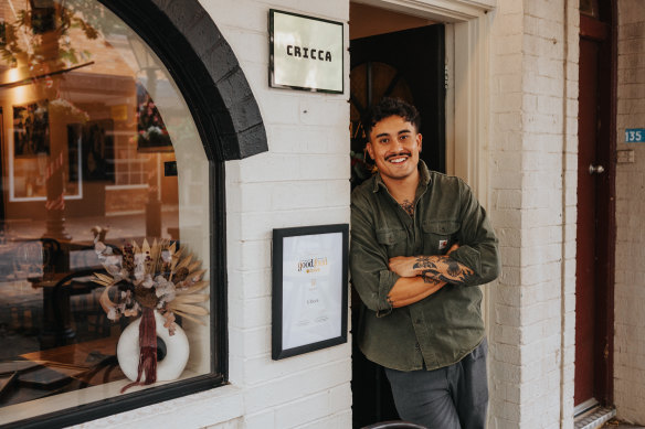 Cricca restaurant manager Alessio Nogarotto next to the Good Food Guide hat certificate his mum framed. 