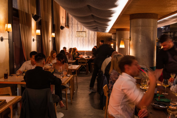 Linen, coiled ropes, banquettes and lamps help soften the dining room at Longshore. 