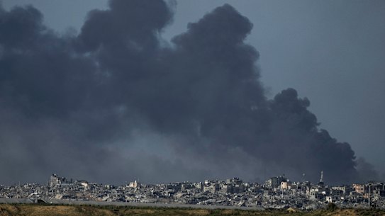 Smoke rises following an Israeli bombardment in the Gaza Strip, as seen from southern Israel on December 26.