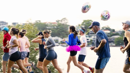 Joggers in the New Farm Park Run celebrating the chance to get active along the Brisbane River.