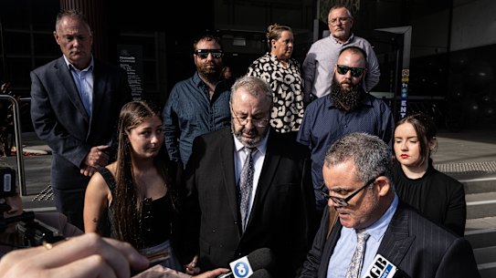 Brett Button, the driver of a charter bus that rolled and killed 10 weddings guests in the Hunter Valley, stands with head bowed as his lawyer reads an apology in Newcastle.