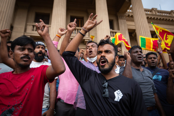 People react in protest to the announcement of newly elected Sri Lankan President Ranil Wickremesinghe.