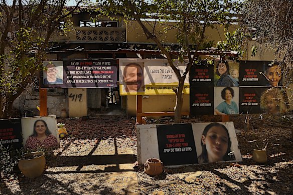 Photographs of a man who was murdered (left), a man taken hostage (right), and women and children, who were taken hostage and then released, in front of their home in Kibbutz Be’eri.