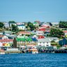 Colourful harbourside homes dominate the barren landscape.