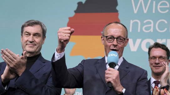 Friedrich Merz, front right, leader of the Christian Democratic Union, gestures while addressing supporters at the party headquarters in Berlin.