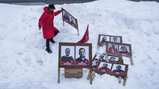 A woman arranges campaign posters in Nuuk, Greenland.