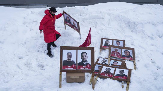 A woman arranges campaign posters in Nuuk, Greenland.