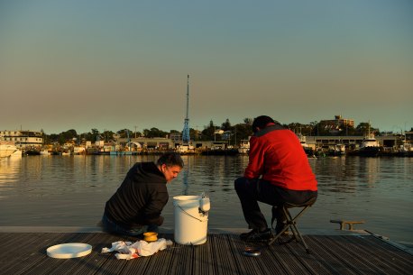 Mucahit Sasmaz (left) and Murat Zengin enjoy an early morning fish down by Rozelle Bay.