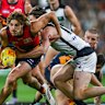 James Peatling of the Crows tackled by Sam Walsh