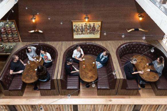 The mezzanine overlooks horseshoe-shaped booths.