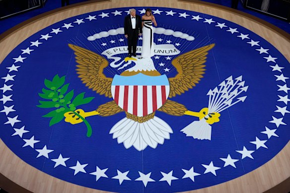 President Donald Trump, left, and first lady Melania Trump stand before dancing at the Commander in Chief Ball.