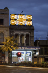 'Never alone' by artist Kent Morris, a digital billboard on St Kilda’s intersection between Grey and Fitzroy Streets. 