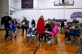 Children wait with their parents after being administered the Pfizer COVID-19 vaccine during a vaccination clinic for ages five-11 hosted by Jewel Osco in Wheeling, Illinois.