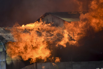 A building burns in Chinatown, in the capital city of Honiara, Solomon Islands, on Friday.