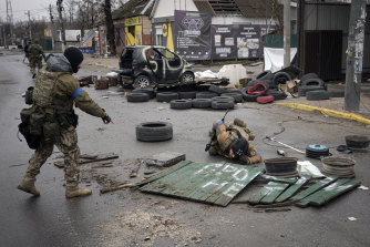 Ukrainian servicemen check streets for booby traps in the formerly Russian-occupied Kyiv suburb of Bucha, Ukraine.