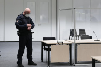 A judicial officer looks at his watch as the start of the trial was delayed.