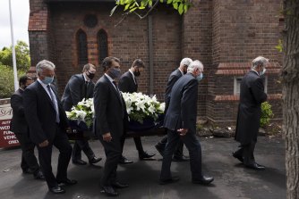 Pallbearers including former Australian captains Steve Waugh, Ian Chappell and Mark Taylor carry the coffin of Alan Davidson on Monday.