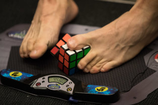 It's a cinch for them: a competitor in the 3x3x3 With Feet category.