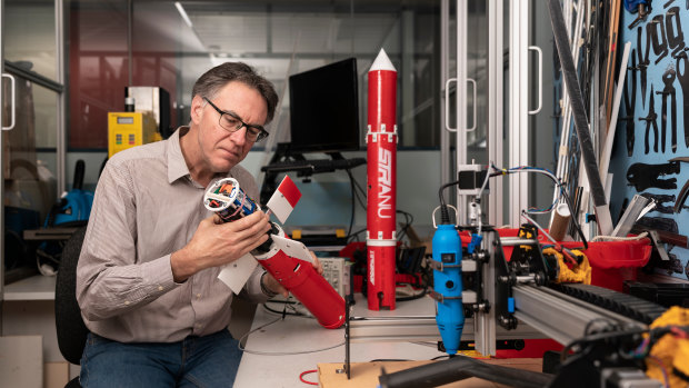 Robotics expert Professor Rob Mahony, who is working on the bushfire warning and extinguishing system, with an autopilot glider that can be remotely guided to water bomb fires. 