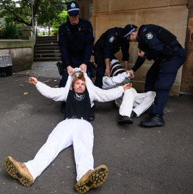 Protesters are arrested on Elizabeth Street on Tuesday morning. 