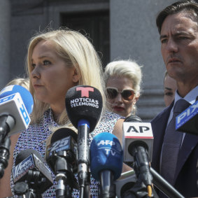 Virginia Roberts Giuffre, who says she was trafficked by sex offender Jeffrey Epstein, holds a news conference outside a Manhattan court with her lawyer, right, Brad Edwards in August last year.