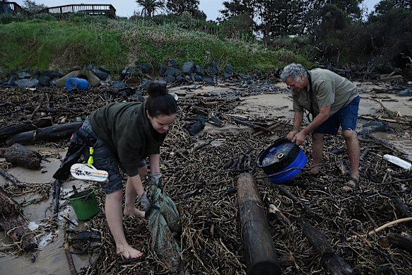 Old Bar residents Matilda Brookhouse, 20, and her father, Kevin Brookhouse, 60, collect plastics and debris from the beach.