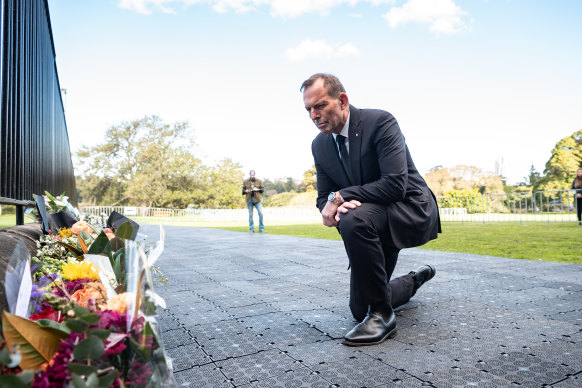 Former prime minister Tony Abbott with a floral tribute to the Queen at Government House in Sydney.