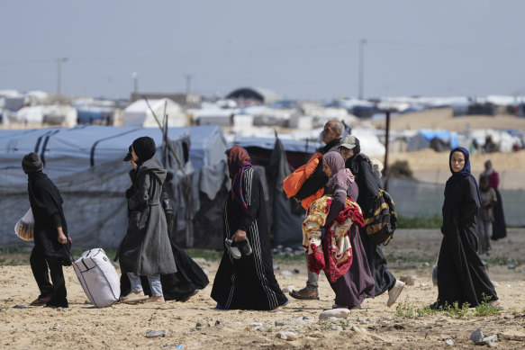 Displaced Palestinians leave Rafah on Sunday as Israel resumes its military operation in the area.