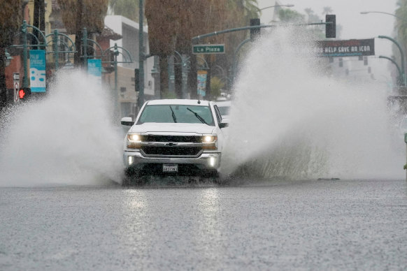 A truck moves through standing water as Tropical Storm Hilary approaches Palm Springs.