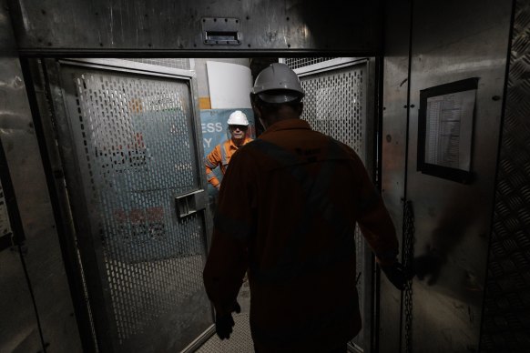 Construction workers take a lift to Pitt Street station near Town Hall.