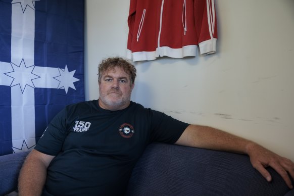 Maritine Union of Australia official Mick Cross in his Port Kembla office, beneath the Eureka flag.