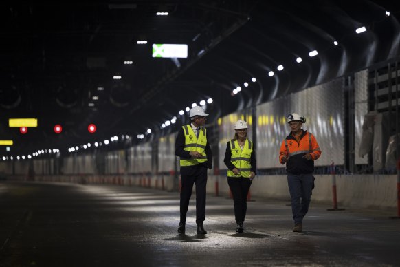 Premier Dominic Perrottet, Metropolitan Roads Minister Natalie Ward and Transurban’s Terry Chapman walk the WestConnex M4-M5 Link tunnel on Thursday.