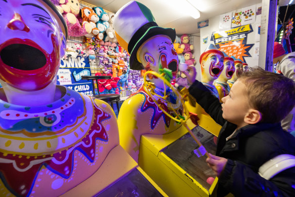 Three-year-old Harry Watts at the launch of the Melbourne Royal Show on Thursday. The laughing clowns game will cost $8 this year. 