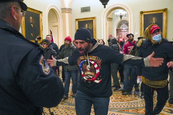 Online fury and disinformation, like the QAnon conspiracy theory signified on the rioter's jumper, was given physical form when rioters stormed the US Capitol.