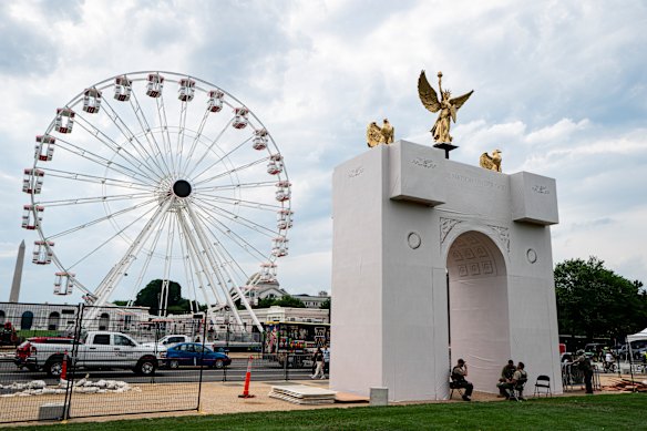 An arch model across the street from the Ferris wheel.
