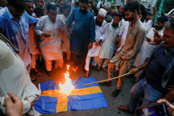 Protesters in Pakistan on July 7 burn the Swedish flag in retaliation for someone burning the Koran in Sweden.