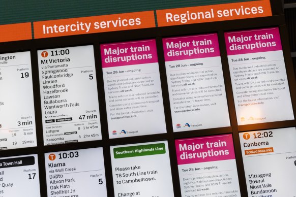 Signs at Central Station warn commuters about the disruptions to train services on Tuesday.