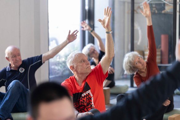 A yoga class involving participants of a program connecting international students and retired Melburnians.